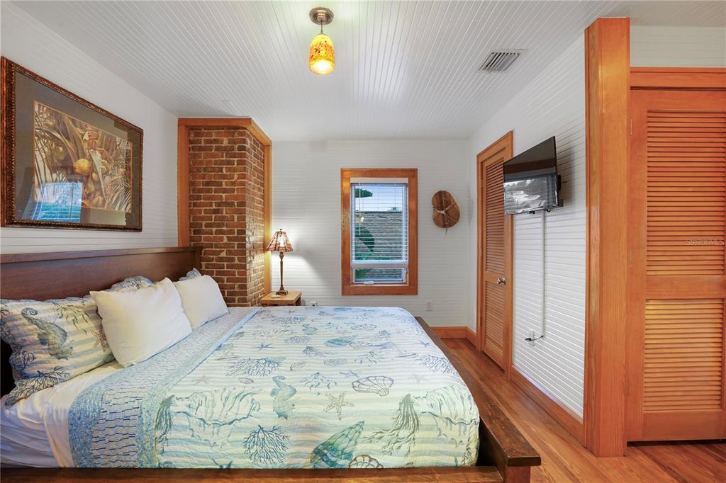 702 Pass A Grille Way St. Pete Beach, FL 33706 - Photo 21 of 41 a bedroom with a bed and a window