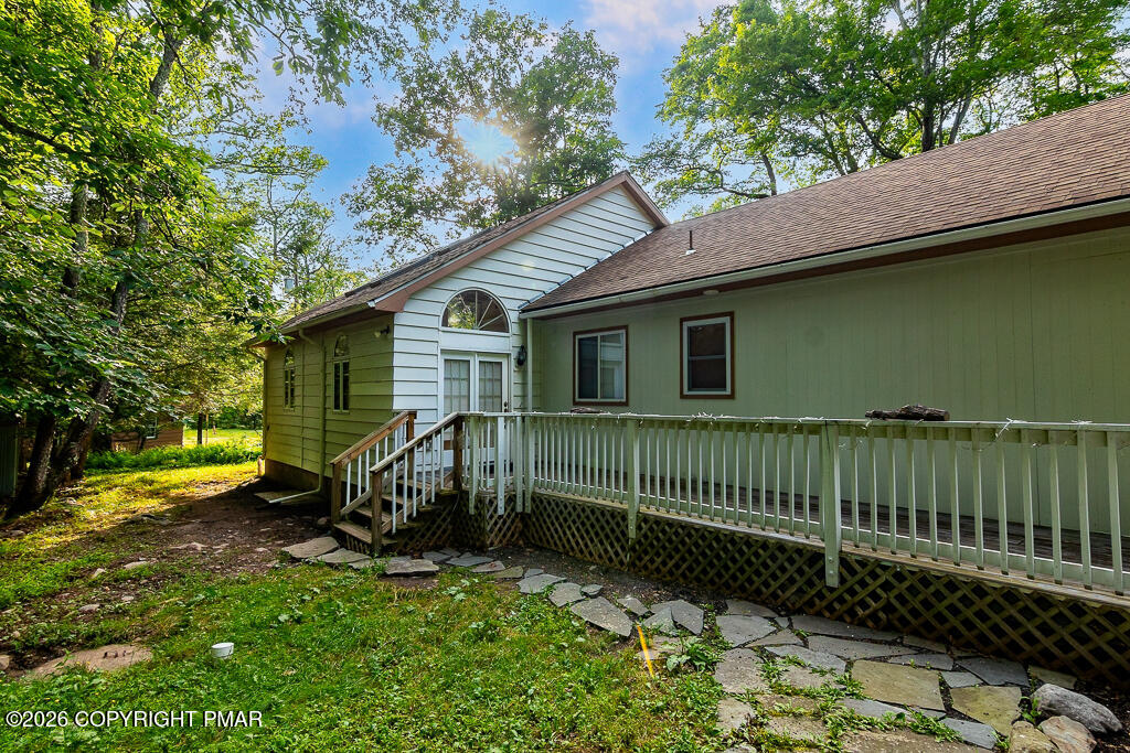 755 White Oak Road Cresco, PA 18326 - Photo 46 of 50 a view of a house with a wooden bench in a yard
