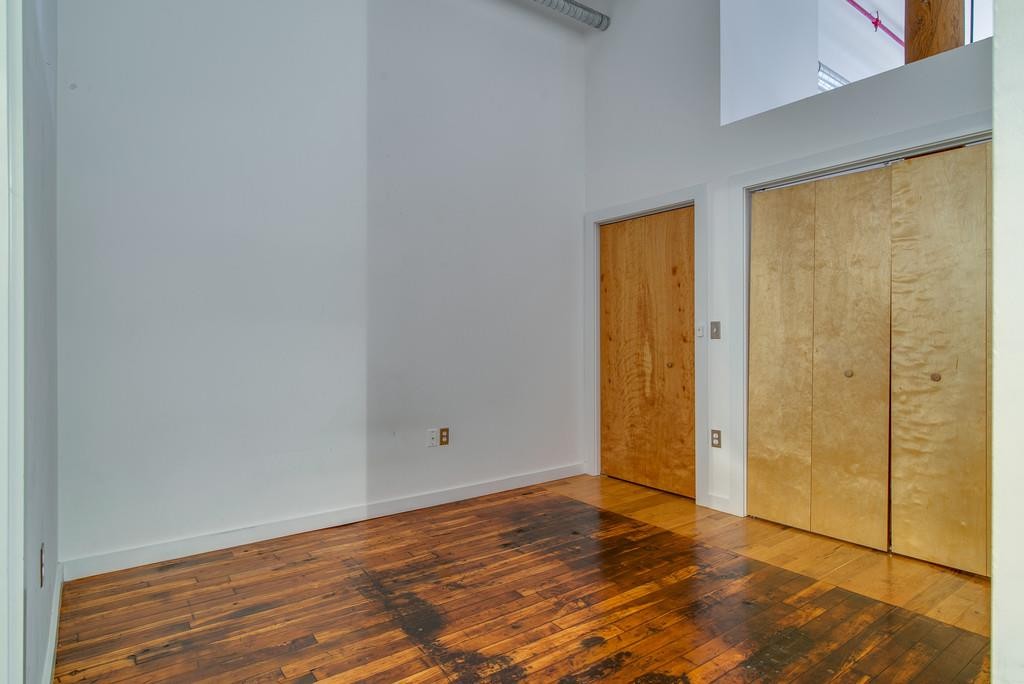 1350 Rosa L Parks Boulevard, Unit 239 Nashville, TN 37208 - Photo 11 of 23 a view of an empty room with wooden floor and door
