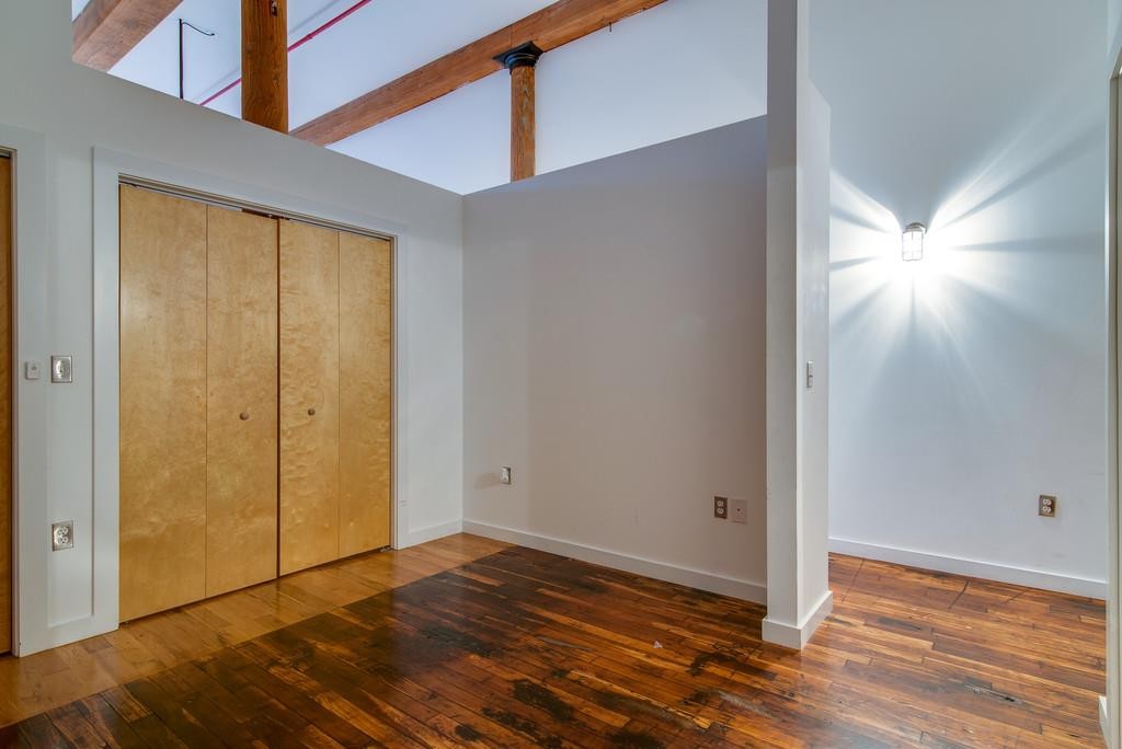 1350 Rosa L Parks Boulevard, Unit 239 Nashville, TN 37208 - Photo 12 of 23 a view of an empty room with wooden floor