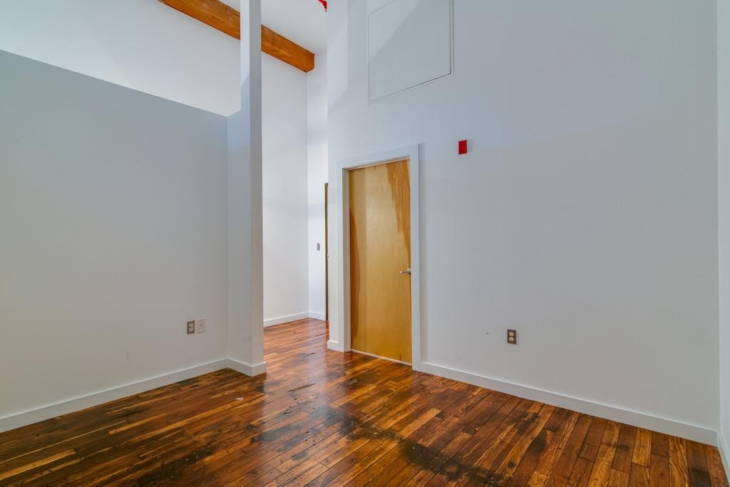 1350 Rosa L Parks Boulevard, Unit 239 Nashville, TN 37208 - Photo 13 of 23 a view of an empty room with wooden floor and a window