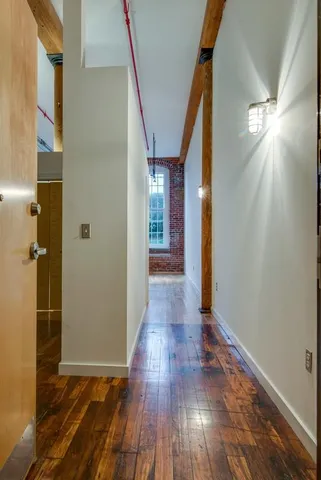 a view of hallway with wooden floor