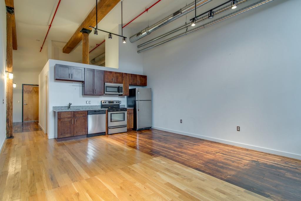 1350 Rosa L Parks Boulevard, Unit 239 Nashville, TN 37208 - Photo 6 of 23 a kitchen with stainless steel appliances granite countertop a sink and cabinets