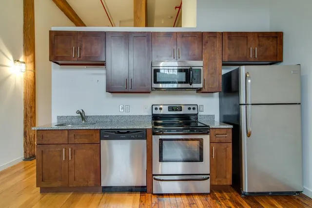 a kitchen with a stove and a refrigerator