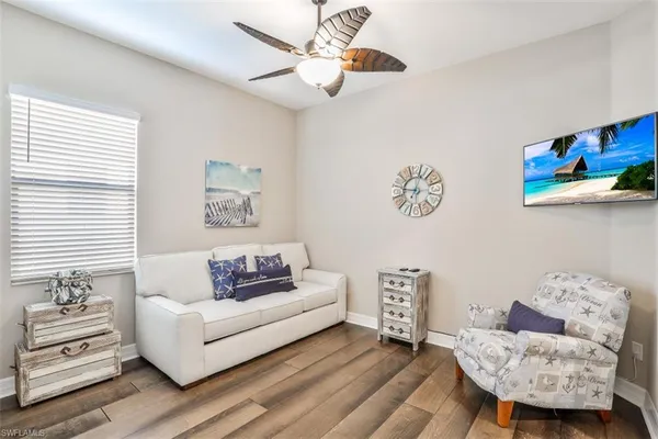 a living room with furniture a bed and a window