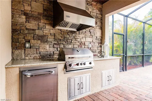 a kitchen with a stove and a wooden floor