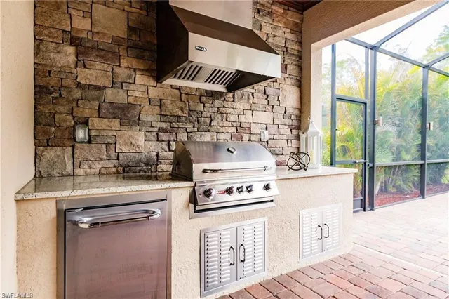a kitchen with a stove and a wooden floor