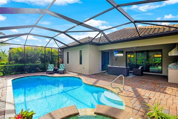 a view of a house with backyard porch and sitting area