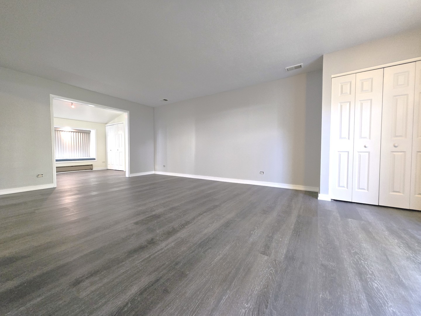 4946 Somerton Drive Hoffman Estates, IL 60010 - Photo 11 of 32 a view of an empty room with wooden floor and a window