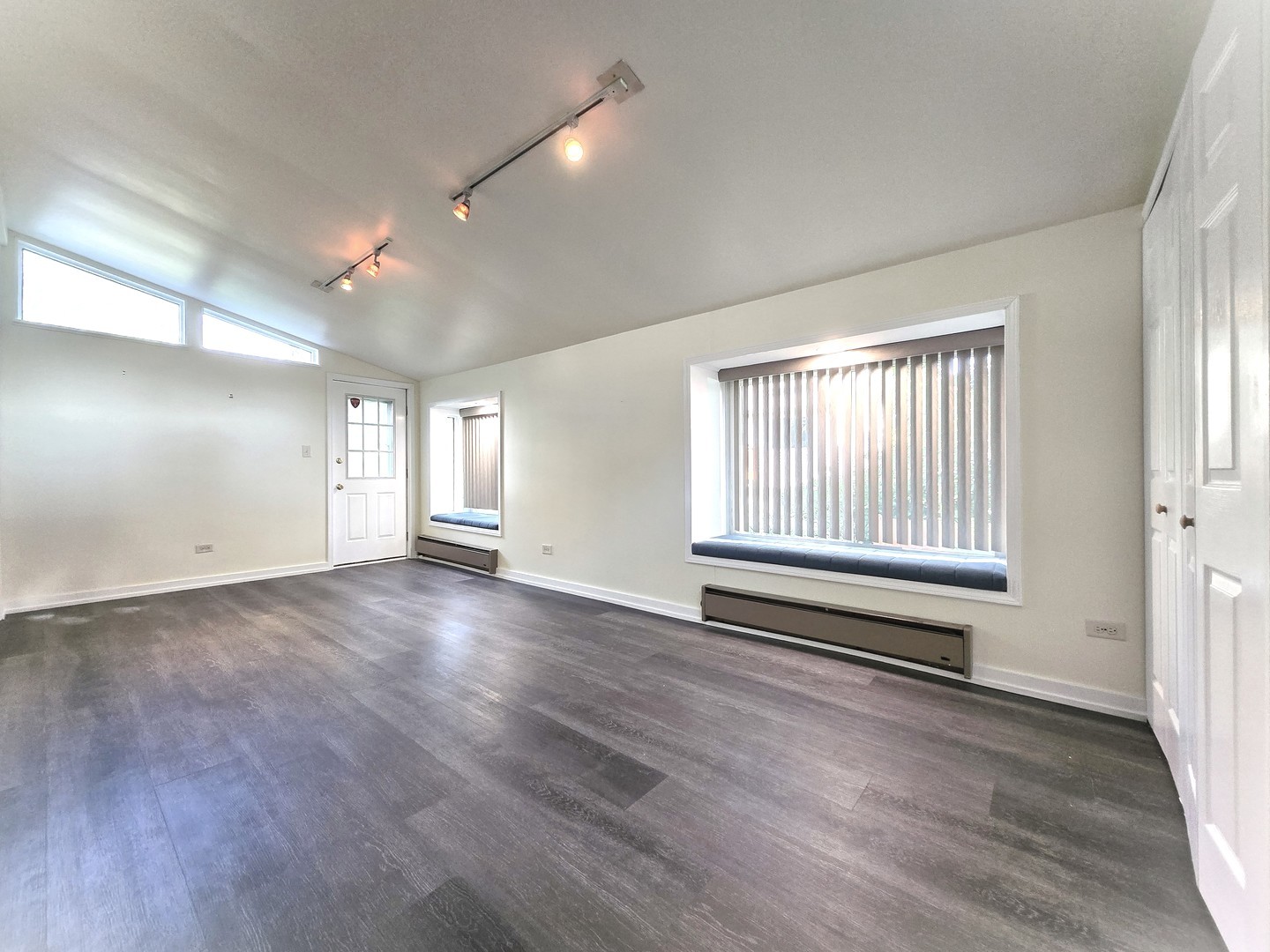 4946 Somerton Drive Hoffman Estates, IL 60010 - Photo 12 of 32 an empty room with wooden floor and windows