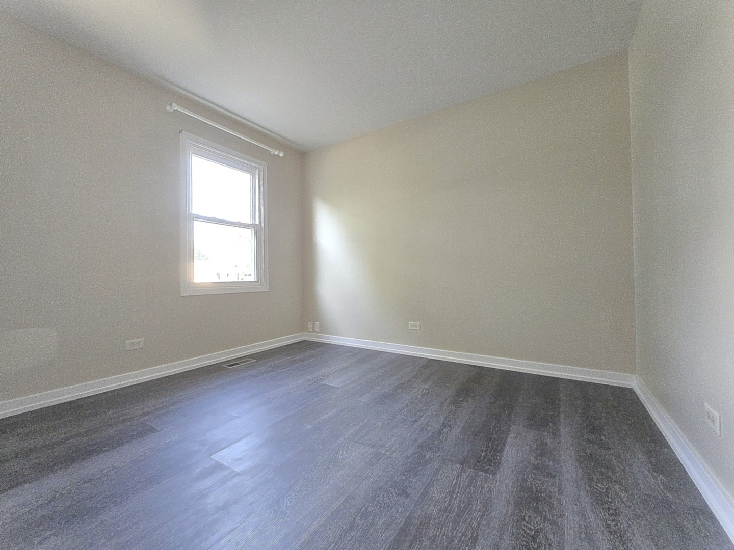 4946 Somerton Drive Hoffman Estates, IL 60010 - Photo 20 of 32 an empty room with wooden floor and windows