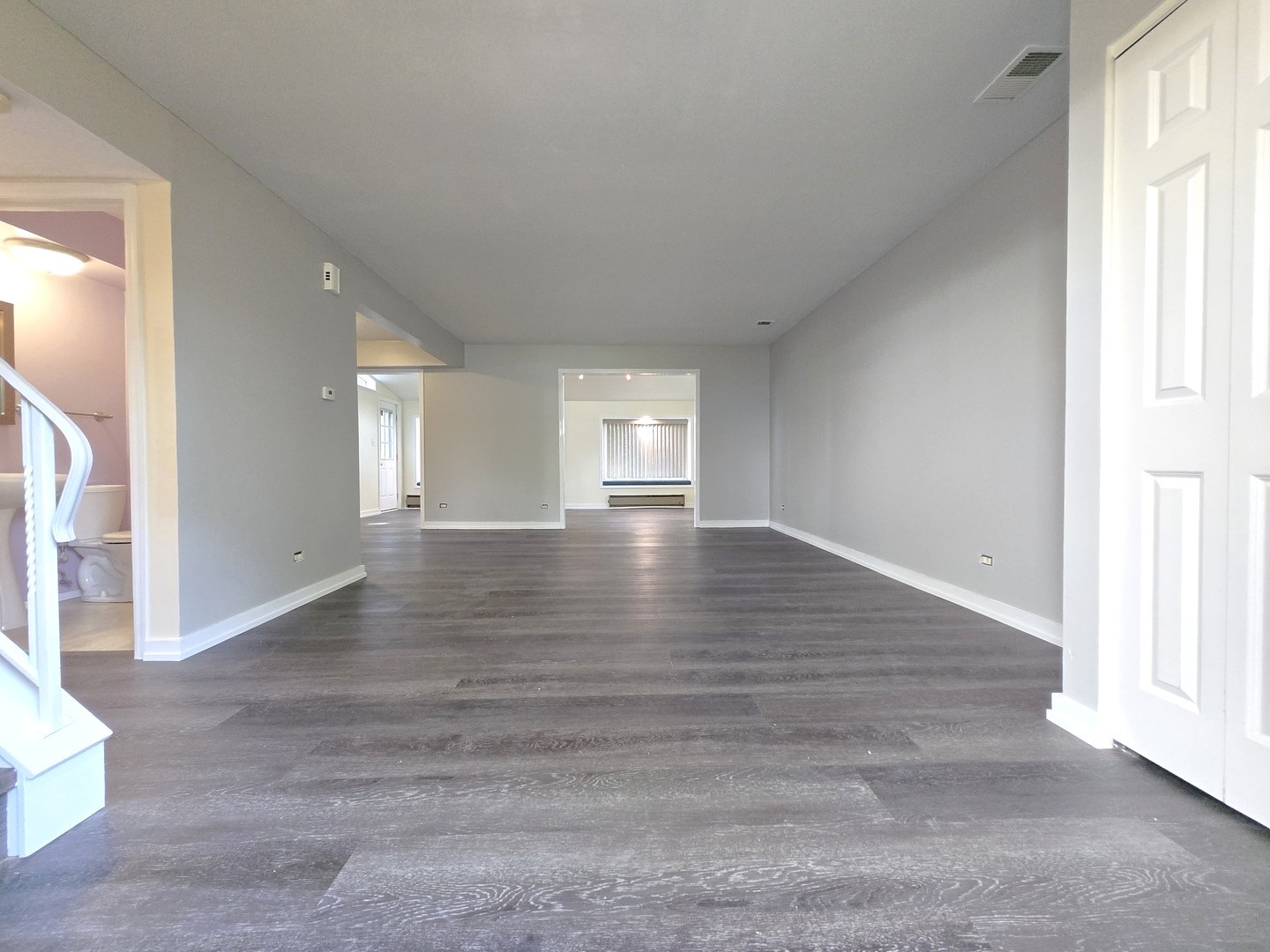 4946 Somerton Drive Hoffman Estates, IL 60010 - Photo 2 of 32 an empty room with wooden floor and windows