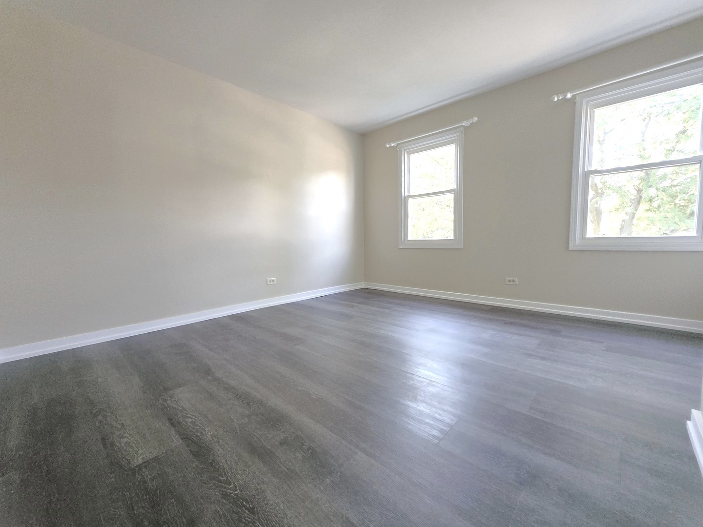 4946 Somerton Drive Hoffman Estates, IL 60010 - Photo 25 of 32 an empty room with wooden floor and windows