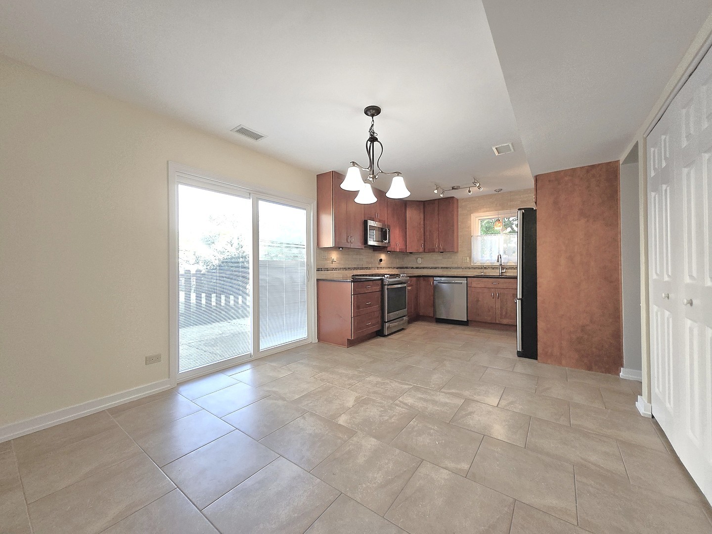 4946 Somerton Drive Hoffman Estates, IL 60010 - Photo 5 of 32 a large kitchen with cabinets and stainless steel appliances