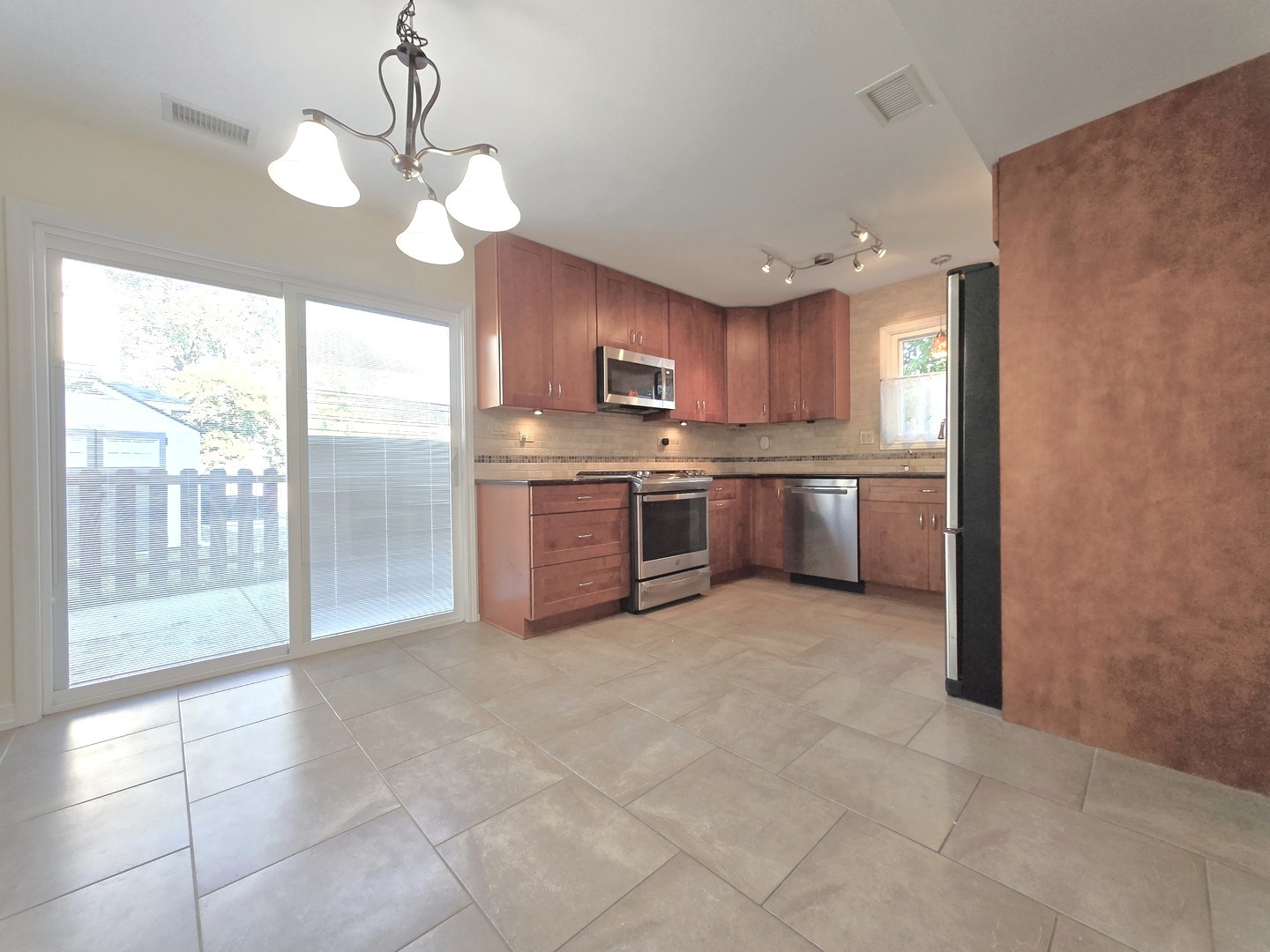 4946 Somerton Drive Hoffman Estates, IL 60010 - Photo 6 of 32 a large kitchen with stainless steel appliances granite countertop a stove a sink and a refrigerator