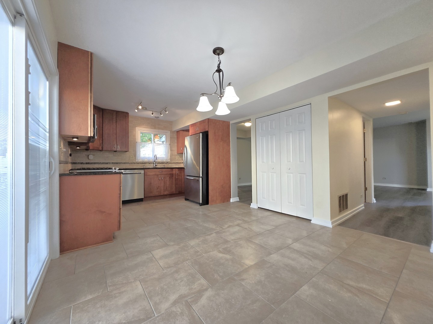 4946 Somerton Drive Hoffman Estates, IL 60010 - Photo 7 of 32 a view of a kitchen with a sink and a large window
