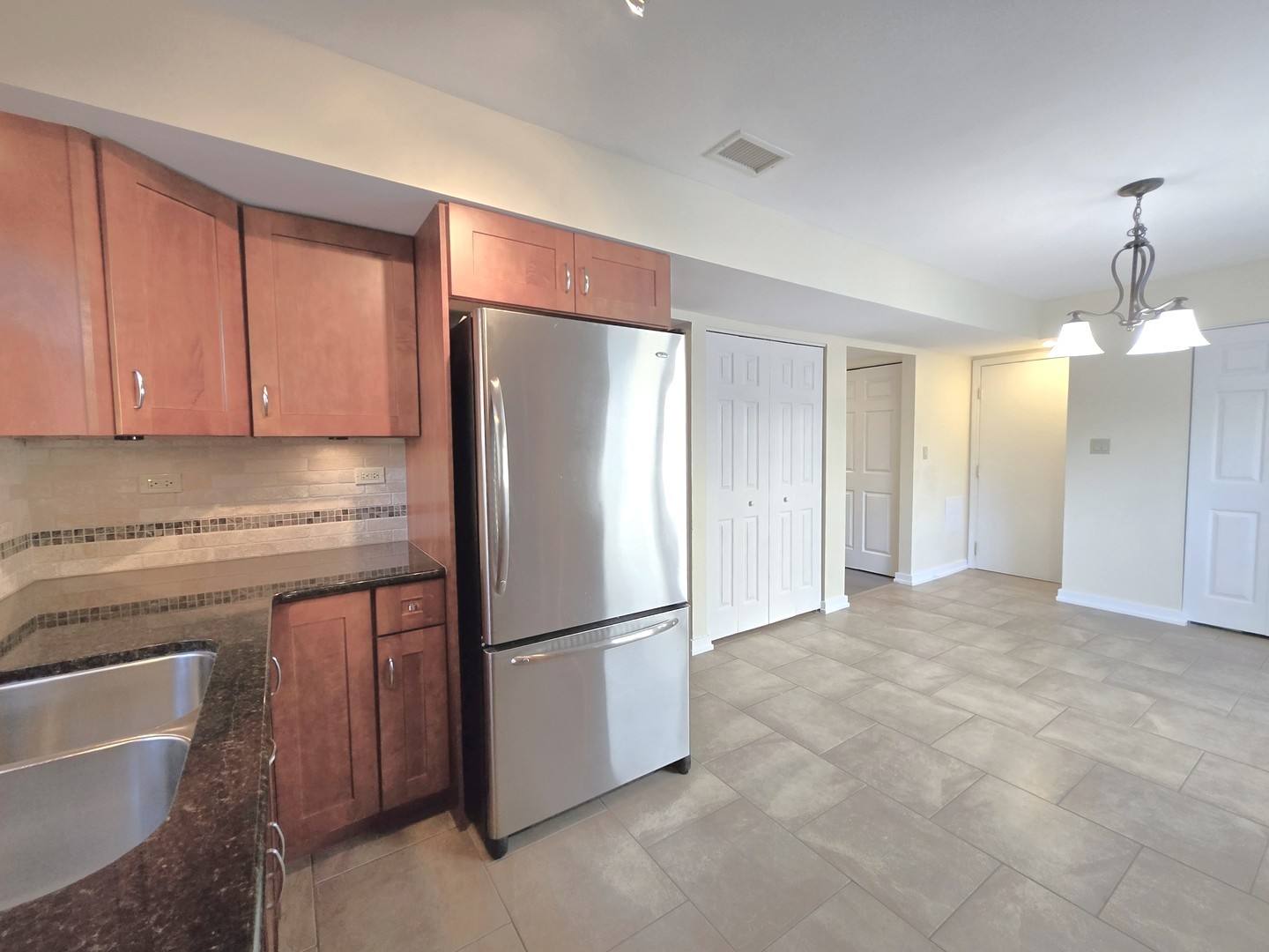 4946 Somerton Drive Hoffman Estates, IL 60010 - Photo 9 of 32 a kitchen with stainless steel appliances granite countertop a refrigerator a sink and a stove