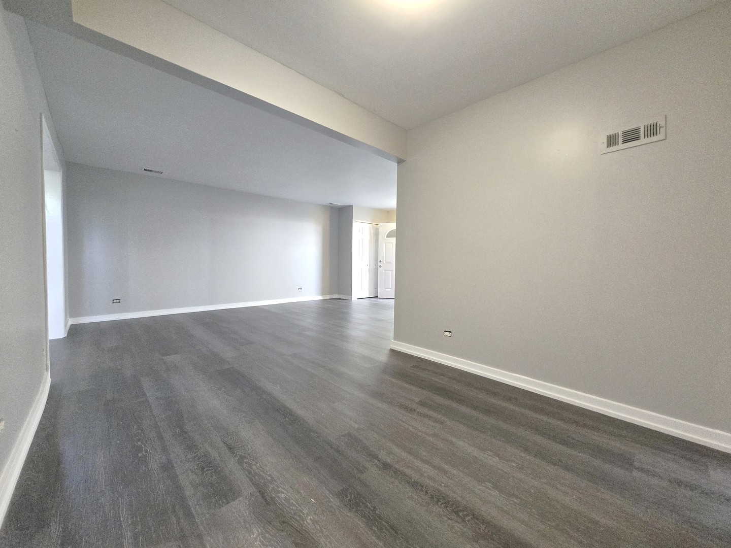 4946 Somerton Drive Hoffman Estates, IL 60010 - Photo 10 of 32 a view of an empty room with wooden floor and a window