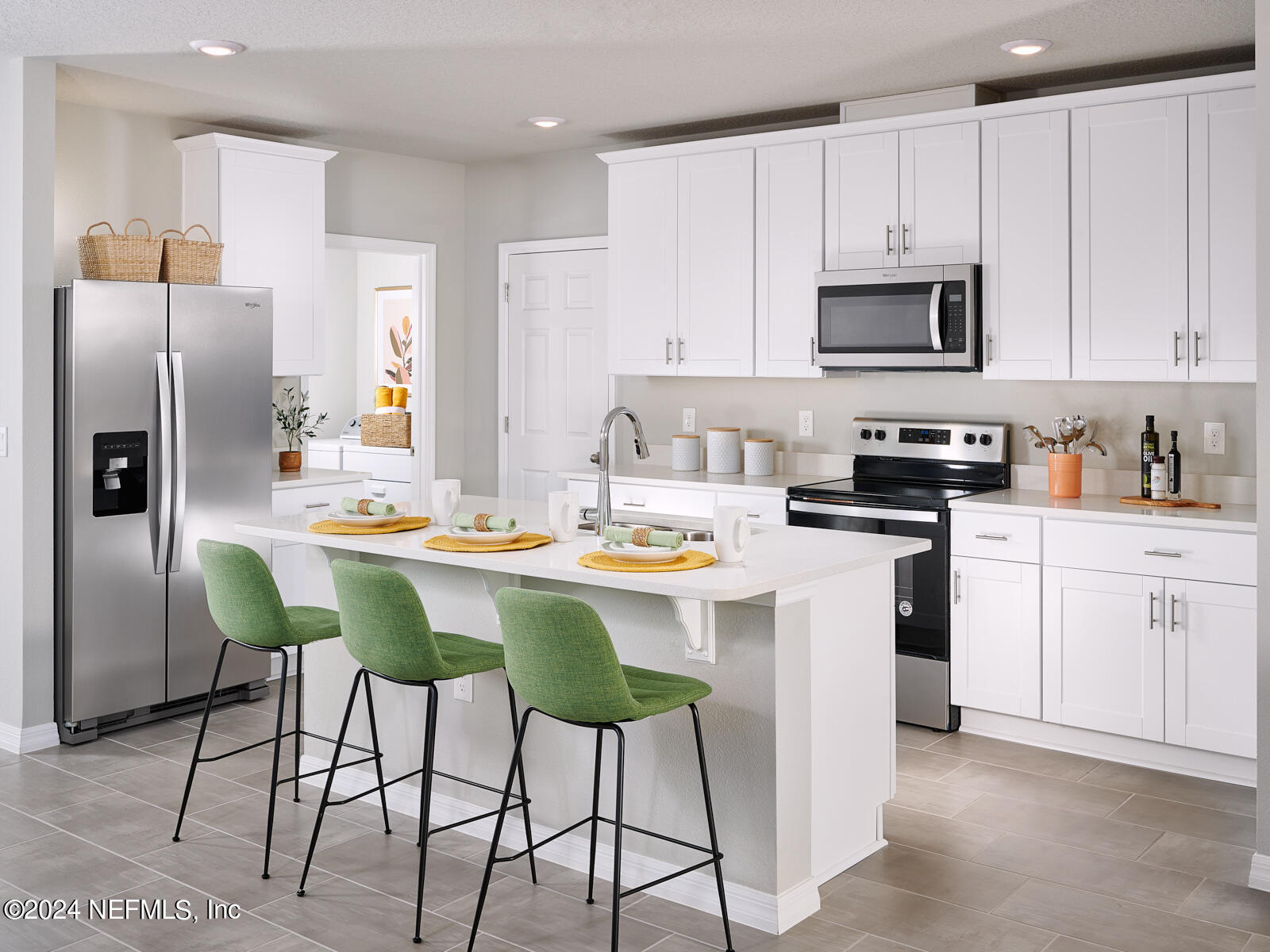 a kitchen with stainless steel appliances kitchen island granite countertop a table chairs microwave and sink
