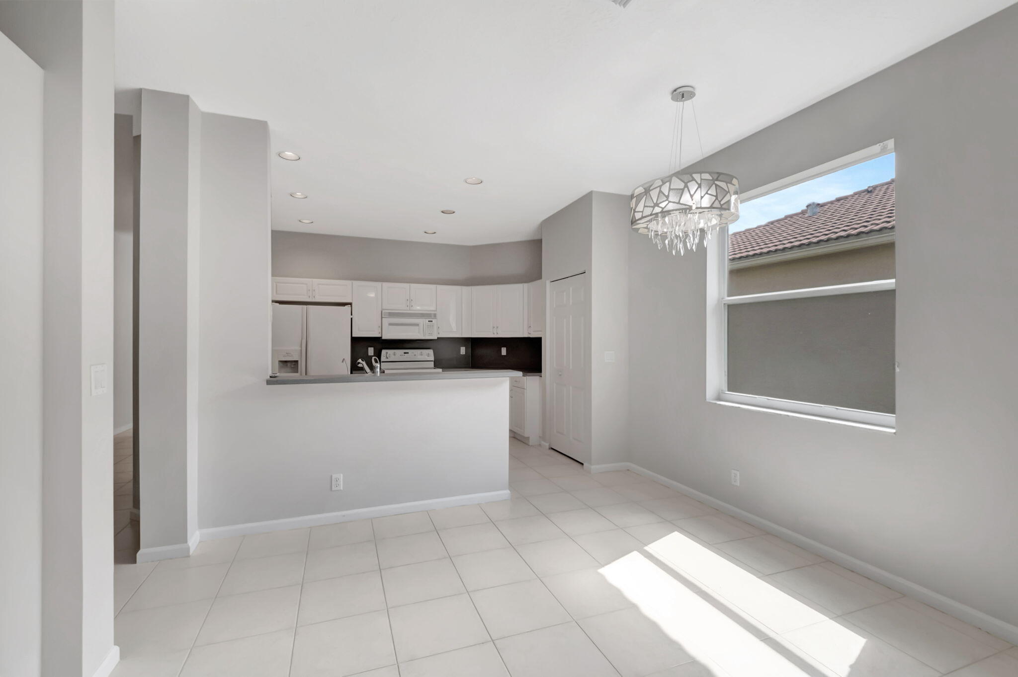 5916 Seashell Terrace Boynton Beach, FL 33437 - Photo 19 of 81 a view of kitchen with refrigerator and window