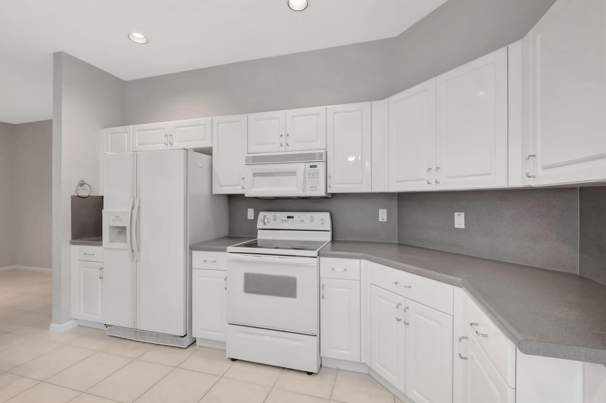 5916 Seashell Terrace Boynton Beach, FL 33437 - Photo 27 of 81 a kitchen with white cabinets and white appliances