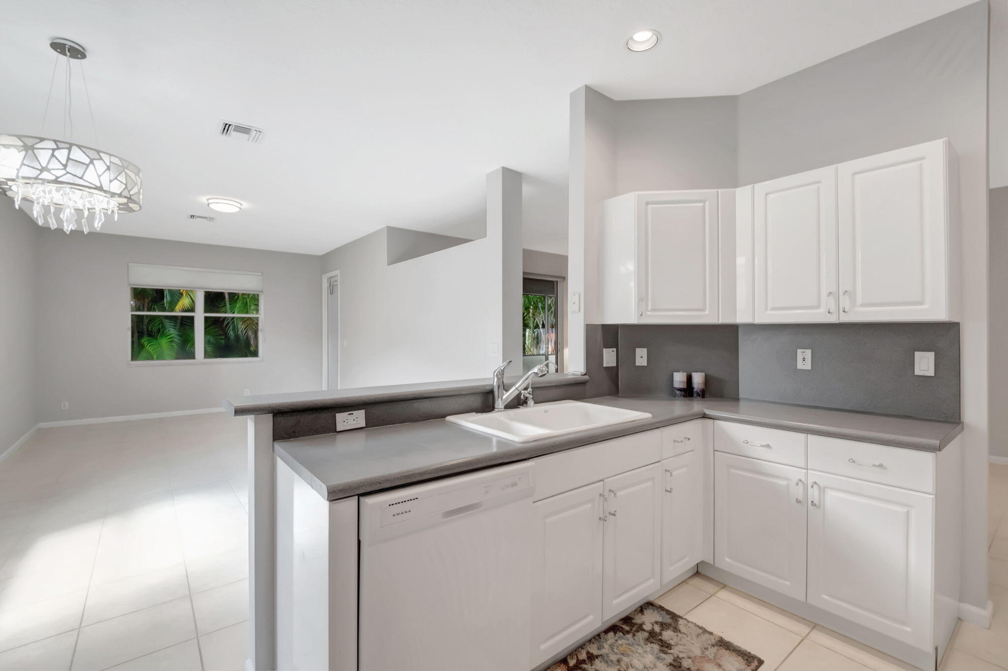 5916 Seashell Terrace Boynton Beach, FL 33437 - Photo 29 of 81 a kitchen with granite countertop white cabinets and white appliances
