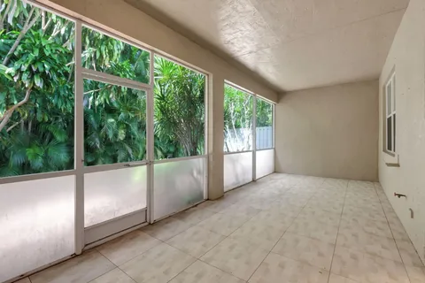 a living room with furniture fireplace and large windows