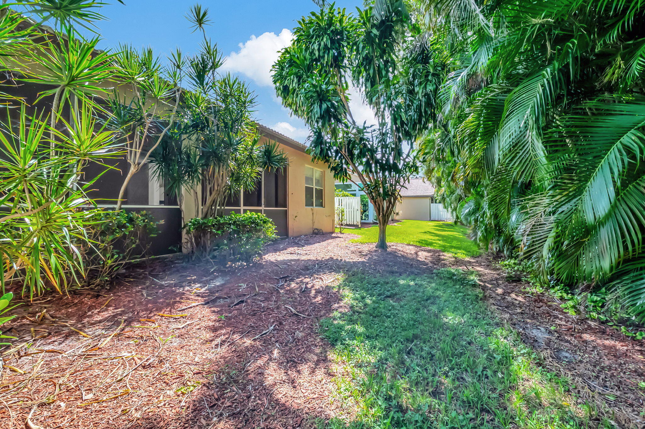 5916 Seashell Terrace Boynton Beach, FL 33437 - Photo 54 of 81 a view of swimming pool with a garden and trees