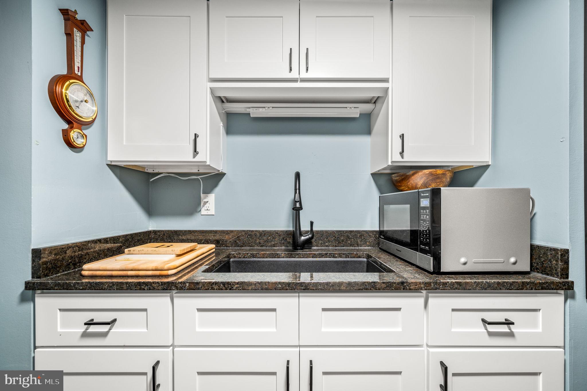 800 Avondale Road, Unit 2P Wallingford, PA 19086 - Photo 7 of 19 New granite countertops and wood cabinets.