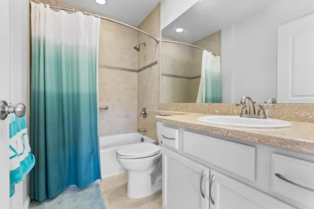 a bathroom with a shower sink and mirror