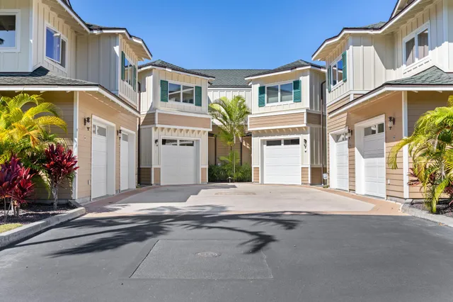 a view of a house with a big yard and large trees