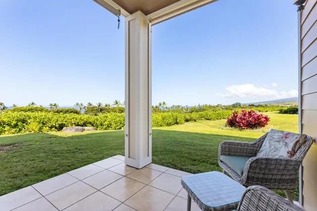 a view of a porch with furniture and garden