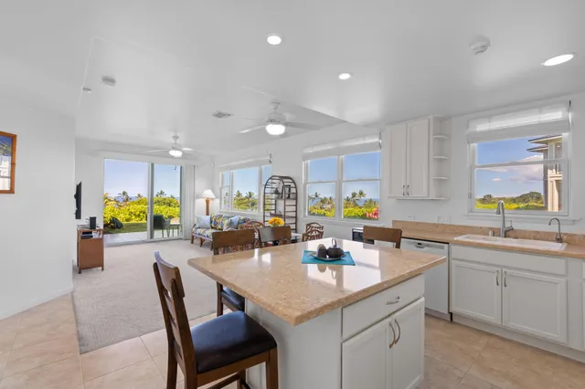 a kitchen with counter and chairs in it