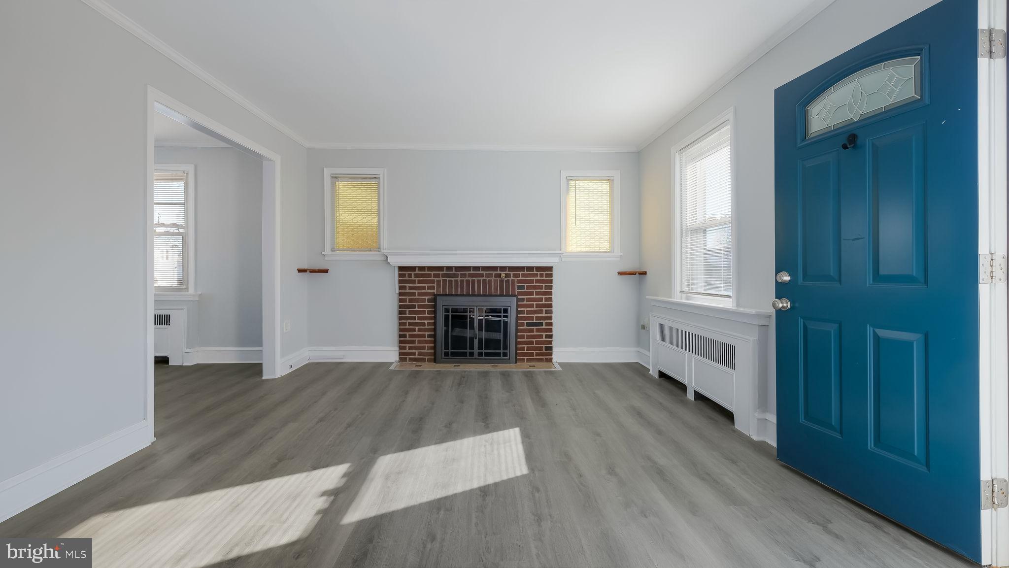 2035 Ripley Street Philadelphia, PA 19152 - Photo 12 of 30 an empty room with wooden floor windows and fireplace