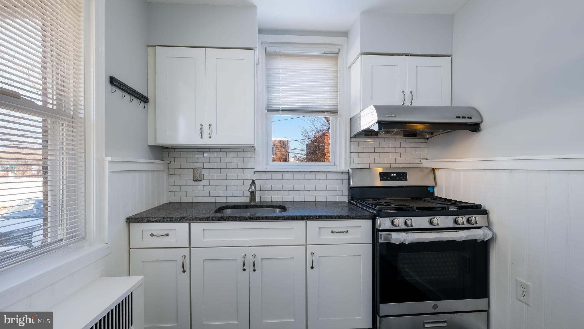 2035 Ripley Street Philadelphia, PA 19152 - Photo 7 of 30 a kitchen with stainless steel appliances granite countertop a stove a sink and a white cabinets