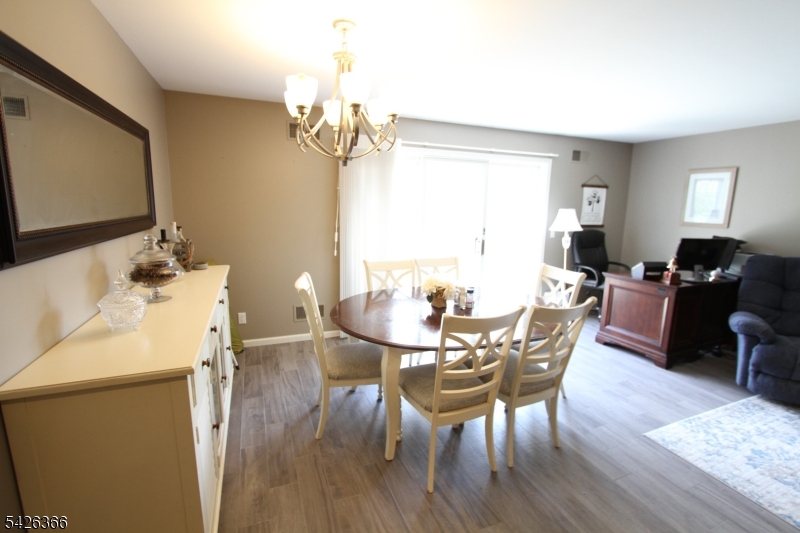 70 Harristown Road, Unit 3 Fair Lawn, NJ 07410 - Photo 12 of 20 a view of a dining room with furniture and wooden floor