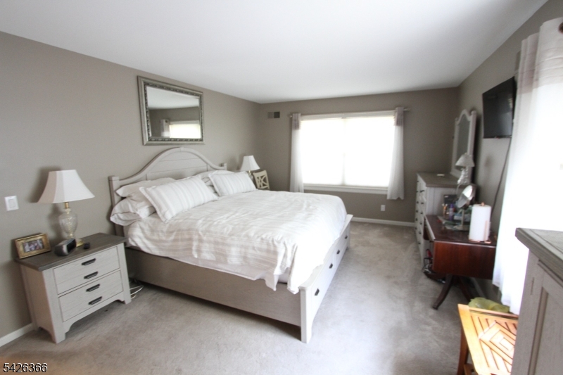 70 Harristown Road, Unit 3 Fair Lawn, NJ 07410 - Photo 14 of 20 a bedroom with a bed and a couch