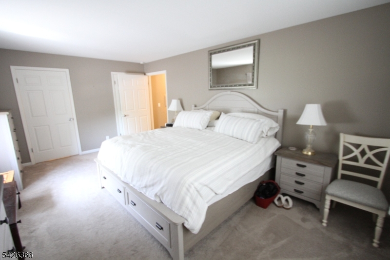 70 Harristown Road, Unit 3 Fair Lawn, NJ 07410 - Photo 15 of 20 a bedroom with a bed a couch and dresser