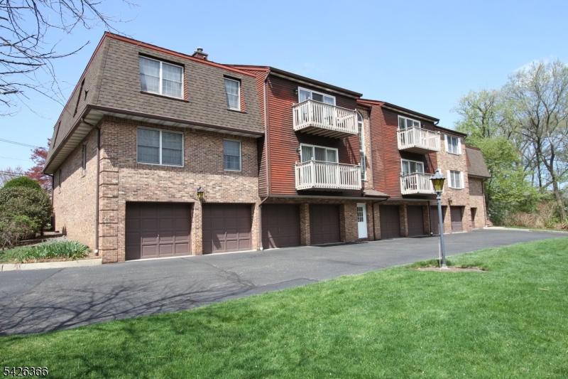 70 Harristown Road, Unit 3 Fair Lawn, NJ 07410 - Photo 2 of 20 a front view of a house with a yard and garage