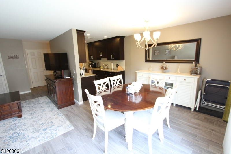70 Harristown Road, Unit 3 Fair Lawn, NJ 07410 - Photo 10 of 20 a dining room with furniture and wooden floor