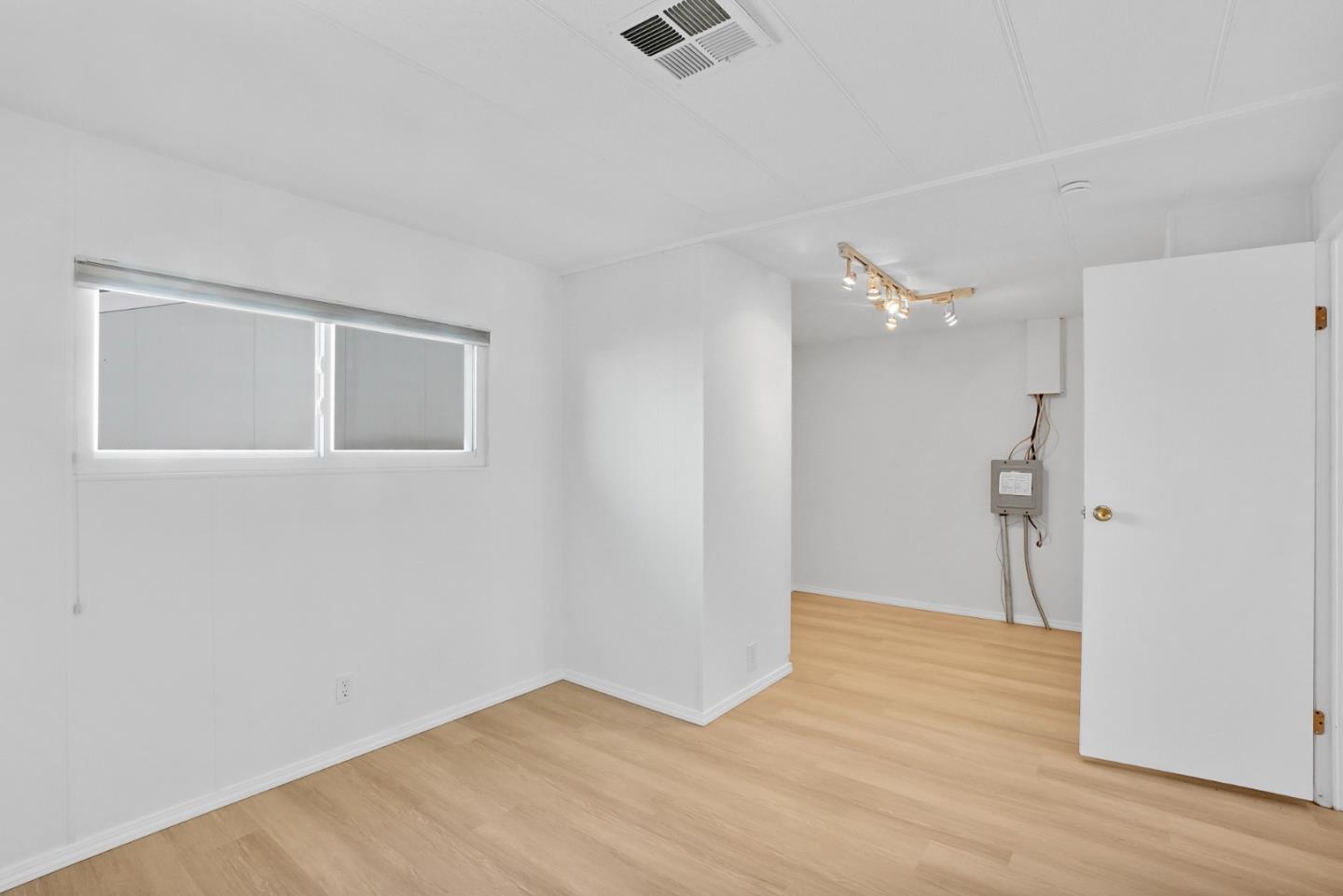 7 Sea Shell Circle, Unit 7 Half Moon Bay, CA 94019 - Photo 17 of 36 a view of an empty room with wooden floor and a ceiling fan