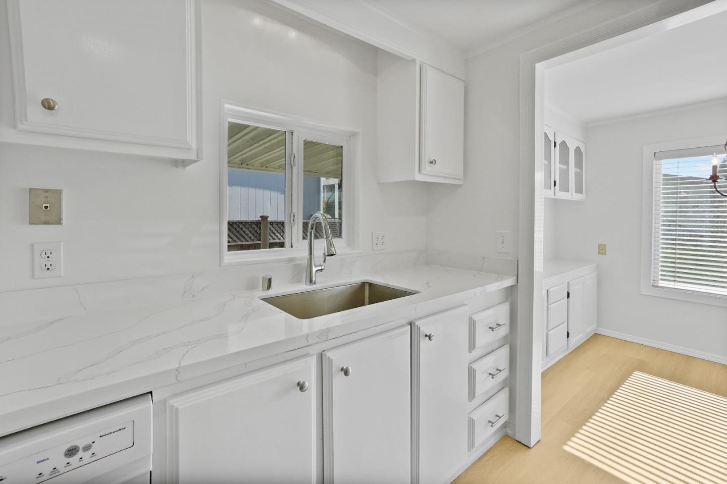 7 Sea Shell Circle, Unit 7 Half Moon Bay, CA 94019 - Photo 22 of 36 a kitchen with a sink and cabinets