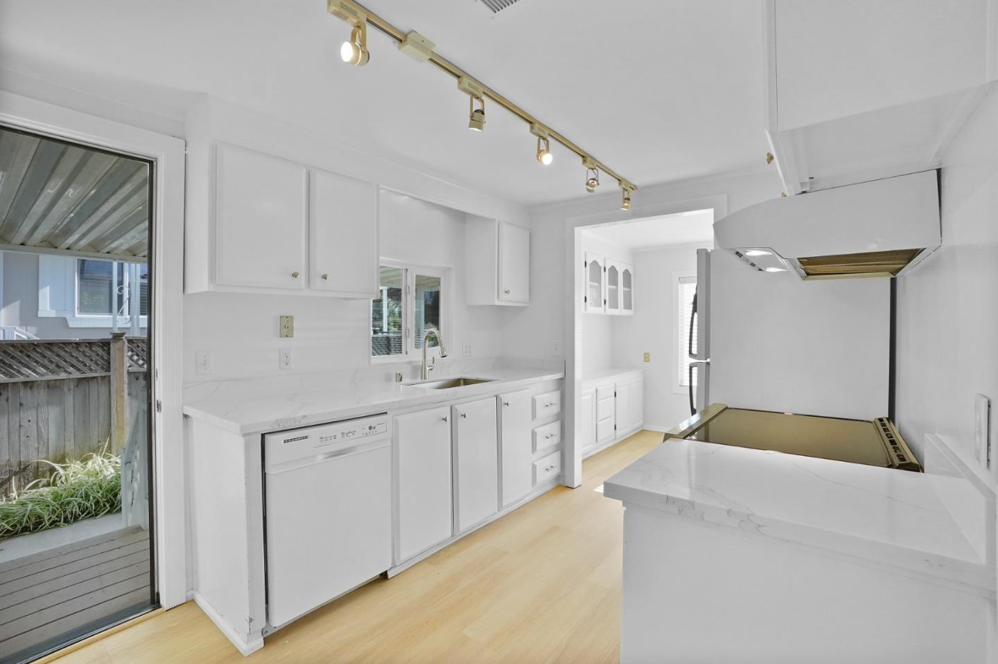 7 Sea Shell Circle, Unit 7 Half Moon Bay, CA 94019 - Photo 4 of 36 a kitchen with white cabinets and sink