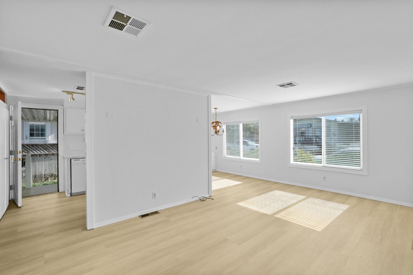 7 Sea Shell Circle, Unit 7 Half Moon Bay, CA 94019 - Photo 9 of 36 a view of an empty room with a window and wooden floor