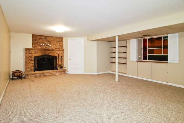 444 Loudon Road Riverside, IL 60546 - Photo 12 of 23 an empty room with a fireplace and cabinet