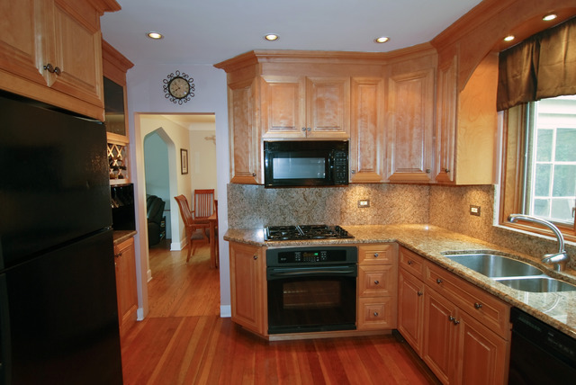 444 Loudon Road Riverside, IL 60546 - Photo 5 of 23 a kitchen with a sink a microwave a stove and refrigerator