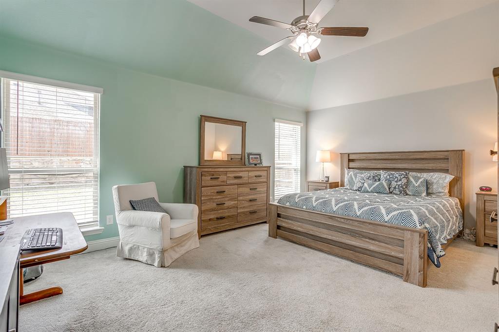 15141 Fleet Hill Road Aledo, TX 76008 - Photo 12 of 37 a spacious bedroom with a bed a couch and a chandelier