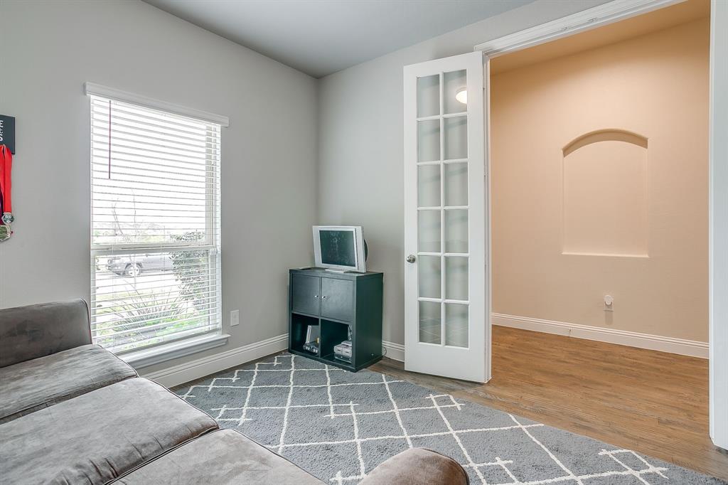15141 Fleet Hill Road Aledo, TX 76008 - Photo 17 of 37 a living room with a black white checkered floor with a dining table and chair
