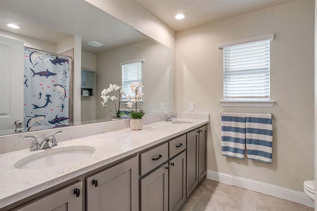 15141 Fleet Hill Road Aledo, TX 76008 - Photo 20 of 37 a bathroom with a granite countertop sink a large mirror a and a shower