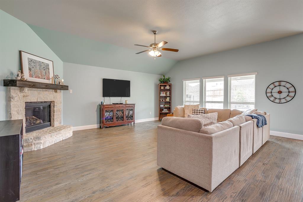 15141 Fleet Hill Road Aledo, TX 76008 - Photo 4 of 37 a living room with furniture a fireplace and a flat screen tv